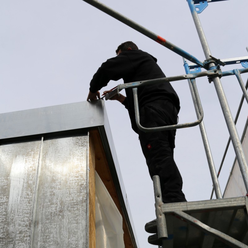 Roofer working on a metal standing seam roof