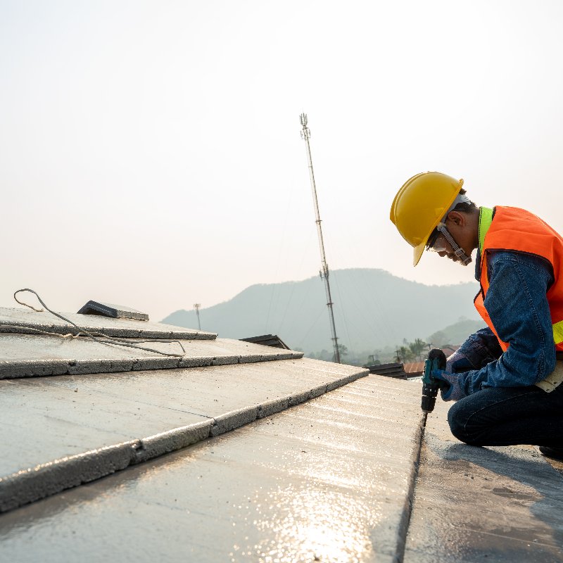worker repairing a commercial metal roof