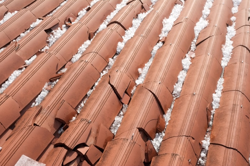 close up of clay roof damaged by hail